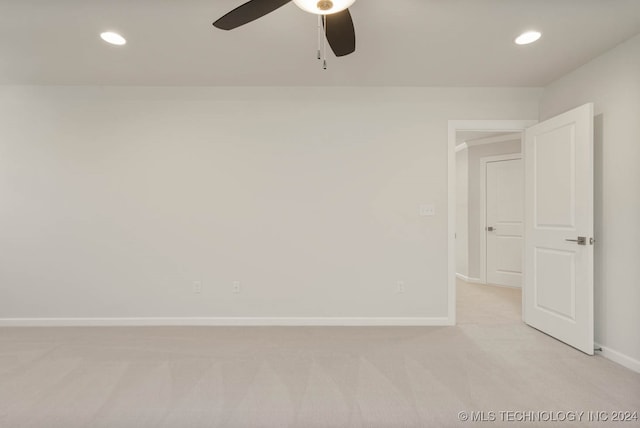 empty room with light colored carpet and ceiling fan