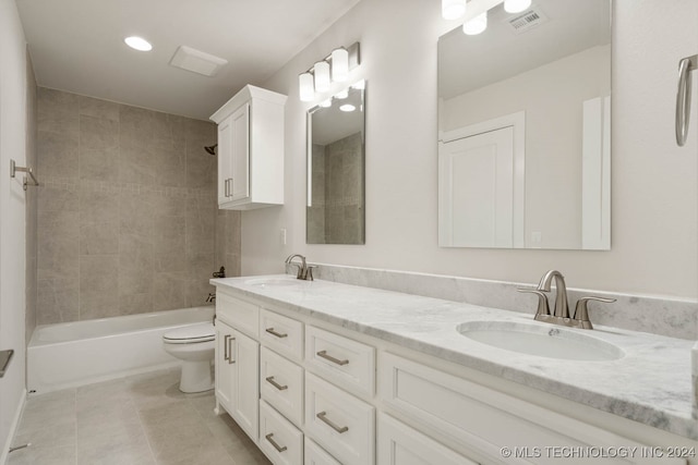 full bathroom featuring tile patterned flooring, vanity, toilet, and tiled shower / bath combo