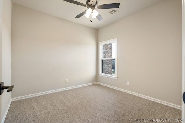 spare room with ceiling fan and light colored carpet