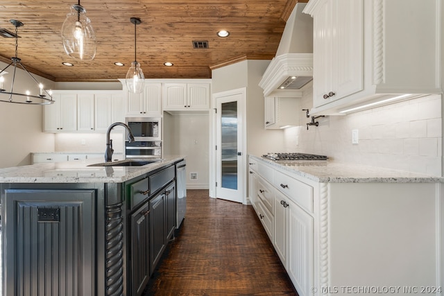 kitchen featuring dark hardwood / wood-style floors, light stone counters, white cabinets, custom range hood, and an inviting chandelier