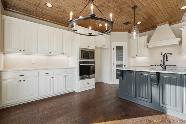 kitchen featuring backsplash, oven, built in microwave, and white cabinetry