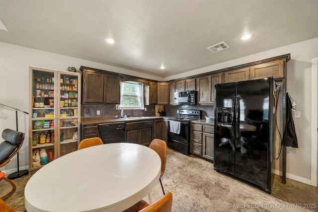 kitchen featuring black appliances, a sink, visible vents, and dark brown cabinetry