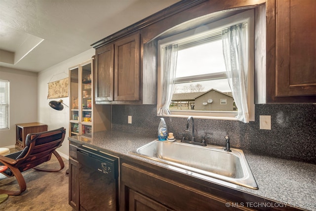 kitchen featuring dark brown cabinets, black dishwasher, decorative backsplash, and a sink