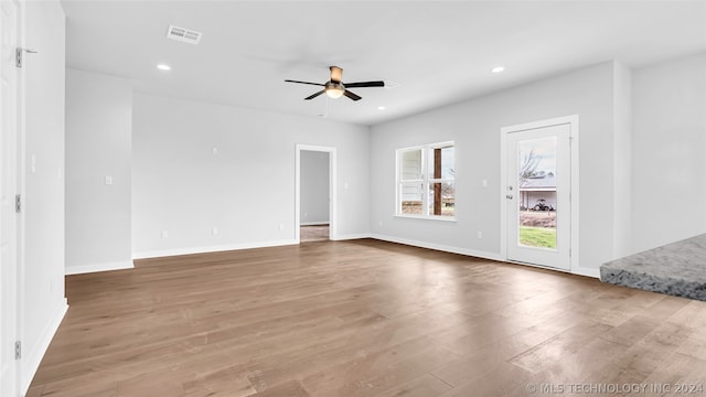 empty room featuring ceiling fan and hardwood / wood-style flooring