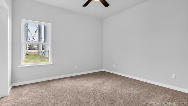 empty room with ceiling fan and carpet flooring