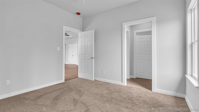 unfurnished bedroom featuring light colored carpet