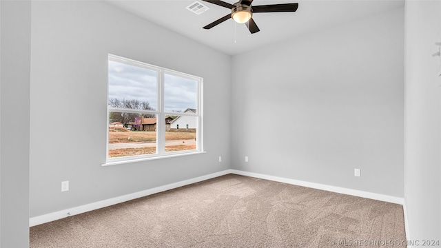 unfurnished room with light colored carpet and ceiling fan