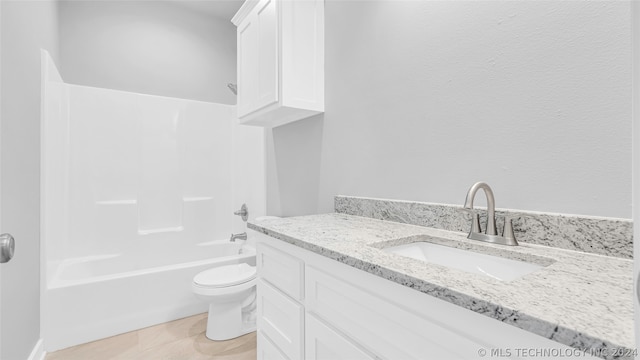 full bathroom featuring shower / washtub combination, toilet, vanity, and tile floors