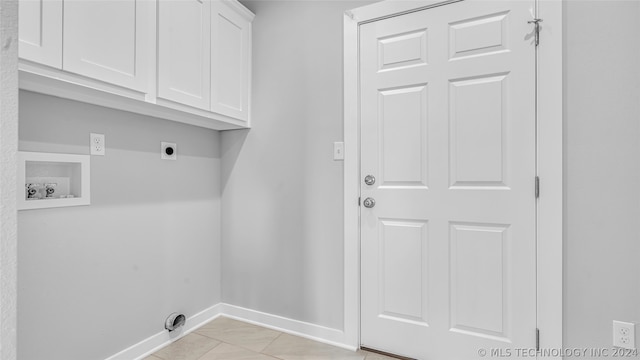 laundry room with cabinets, hookup for an electric dryer, light tile floors, and hookup for a washing machine