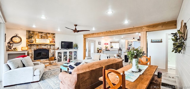 living room featuring hardwood / wood-style floors, a fireplace, and ceiling fan