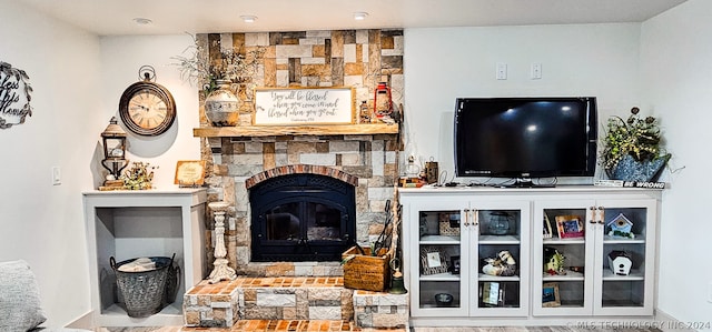 living room featuring a stone fireplace