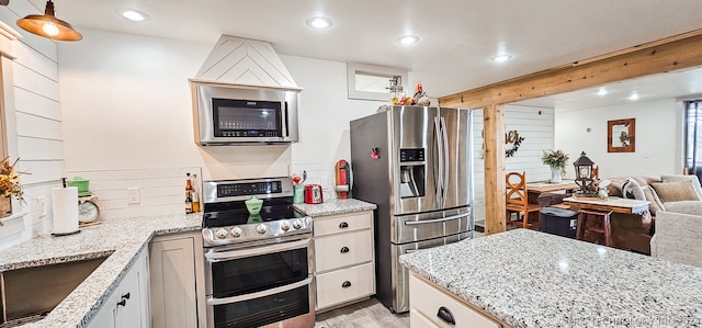 kitchen featuring appliances with stainless steel finishes, white cabinets, and backsplash