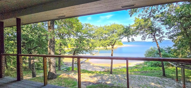 wooden terrace featuring a water view