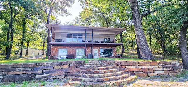 rear view of property featuring a balcony