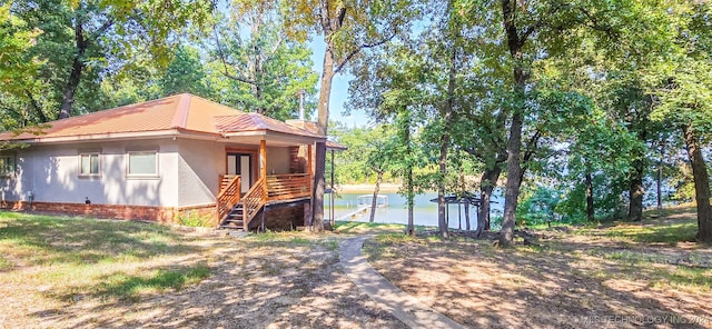 view of property exterior with a water view