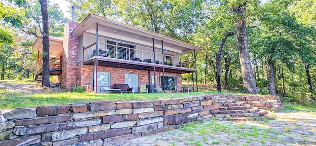 back of house featuring a balcony