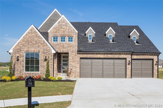 view of front of house featuring a front yard and a garage