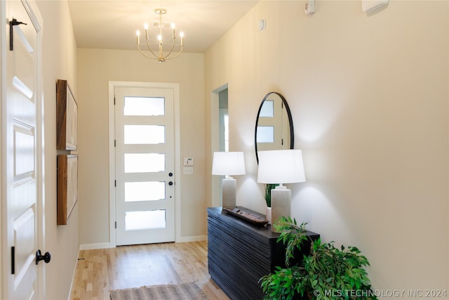 entryway with a chandelier and light hardwood / wood-style flooring