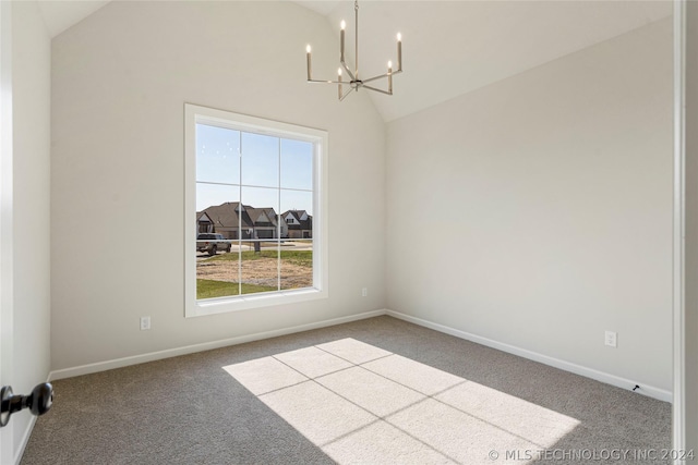 empty room with carpet floors, lofted ceiling, and a notable chandelier