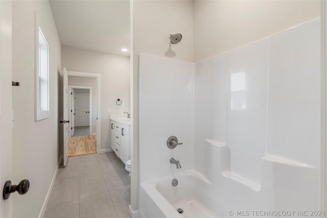 full bathroom with toilet, vanity, tile patterned floors, and shower / washtub combination