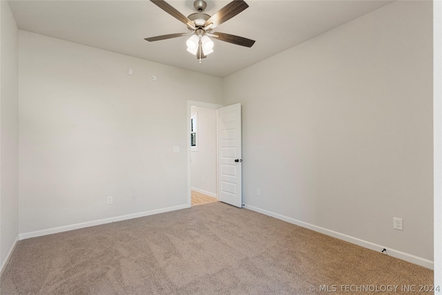 empty room featuring ceiling fan and light carpet