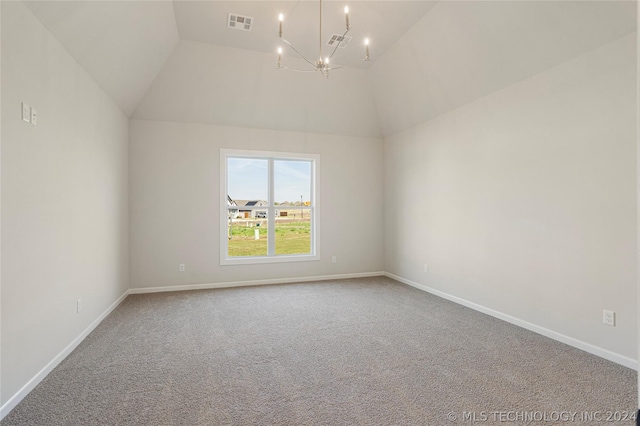 carpeted spare room featuring vaulted ceiling and a chandelier