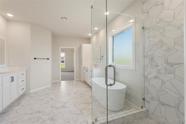 bathroom featuring vanity and shower with separate bathtub