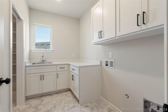 laundry area with cabinets, sink, and washer hookup