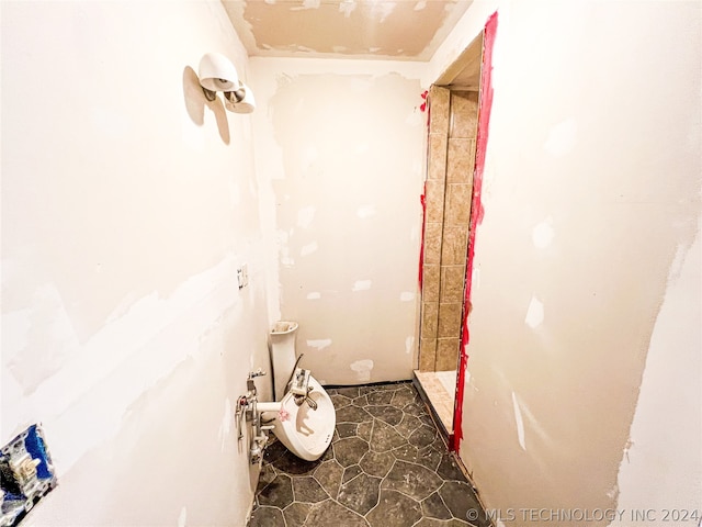 bathroom featuring tile flooring and walk in shower