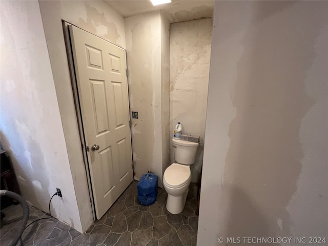 bathroom with tile floors and toilet