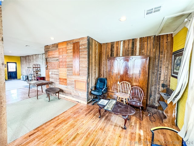 living area featuring wooden walls and light wood-type flooring