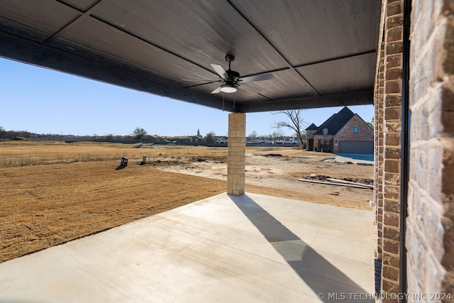 view of patio / terrace featuring a rural view and ceiling fan