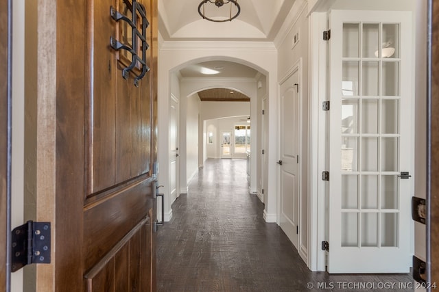 hallway featuring crown molding, dark hardwood / wood-style flooring, and vaulted ceiling