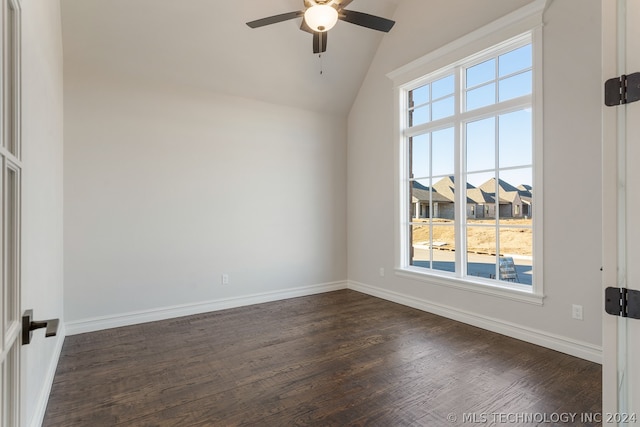 spare room with dark hardwood / wood-style flooring, ceiling fan, a healthy amount of sunlight, and vaulted ceiling