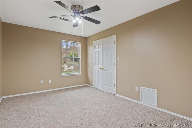 unfurnished room featuring carpet and ceiling fan