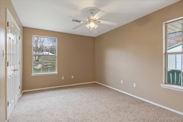 spare room with carpet and ceiling fan