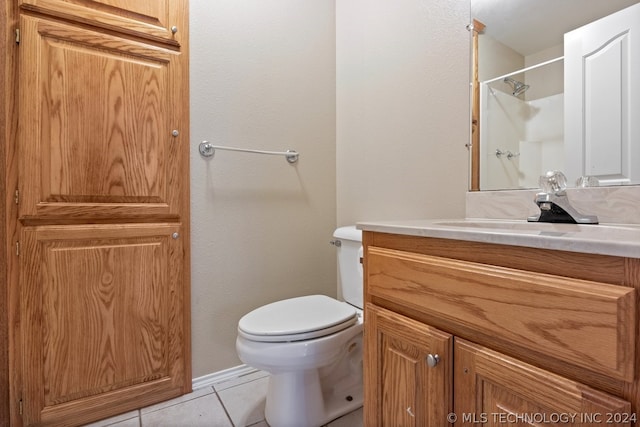 bathroom featuring vanity, toilet, and tile floors