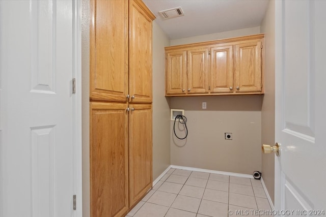 laundry room featuring cabinets, washer hookup, light tile flooring, and hookup for an electric dryer