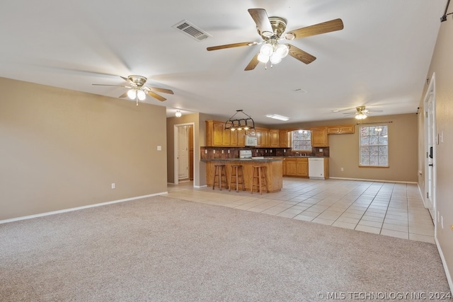 unfurnished living room with ceiling fan and light tile floors