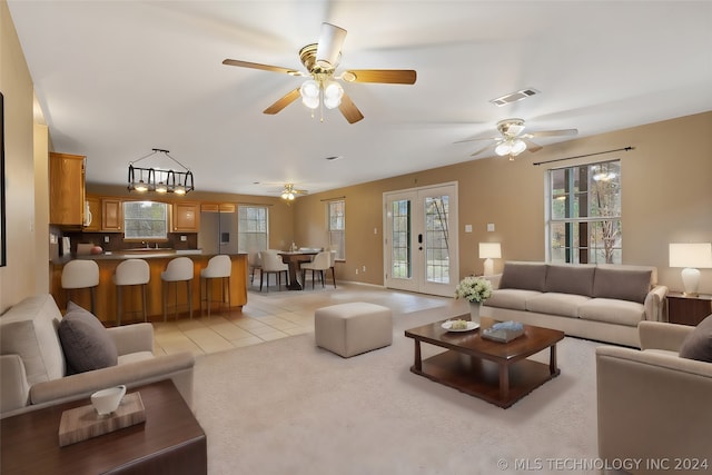 living room featuring plenty of natural light, ceiling fan, and light tile floors