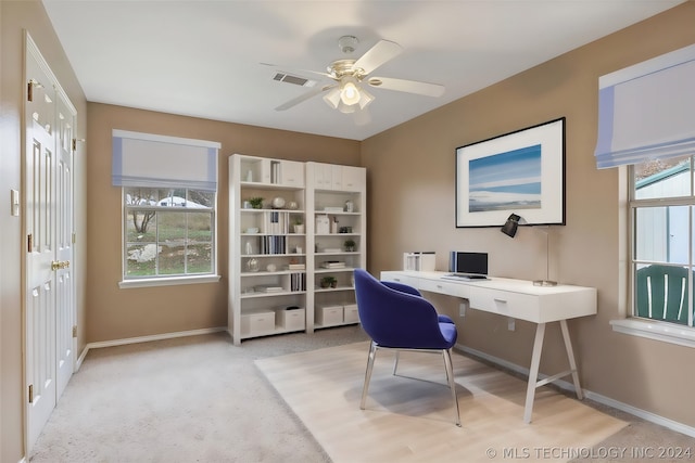 office space featuring ceiling fan and light colored carpet