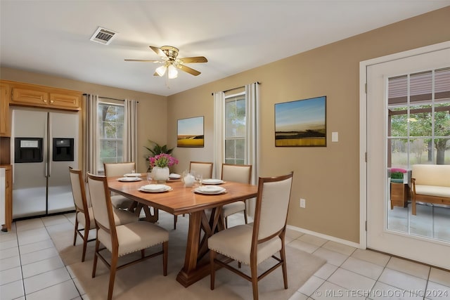 dining area with ceiling fan and light tile flooring