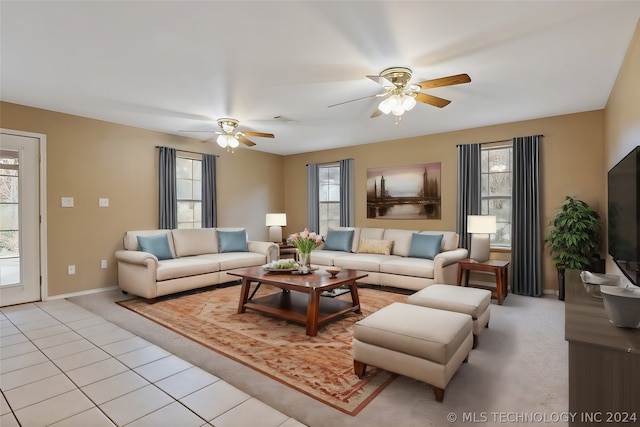 living room featuring a healthy amount of sunlight, ceiling fan, and light tile floors