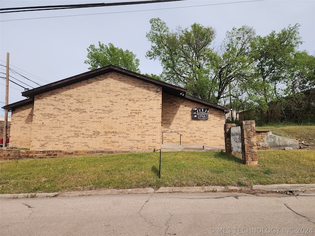 view of property exterior with a yard