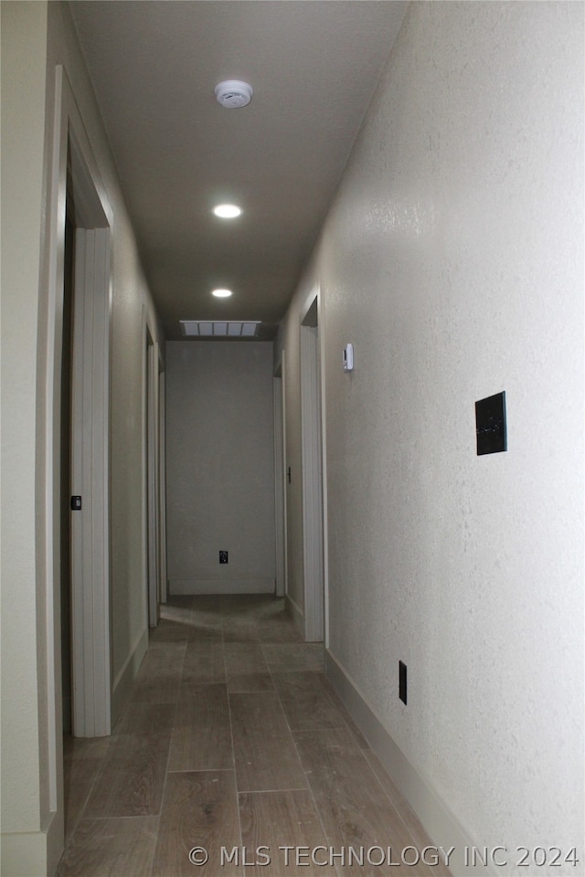 hall featuring dark tile floors