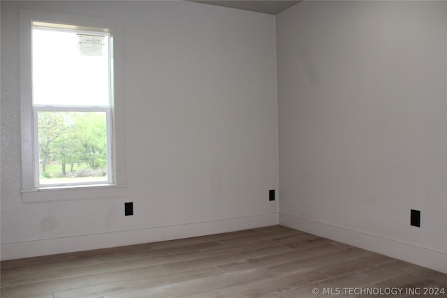 spare room featuring wood-type flooring