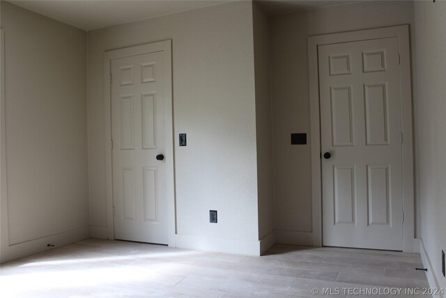 unfurnished bedroom featuring light hardwood / wood-style floors and a closet