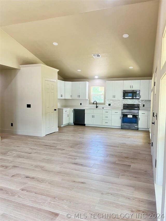 kitchen with lofted ceiling, light hardwood / wood-style flooring, white cabinets, electric stove, and dishwasher