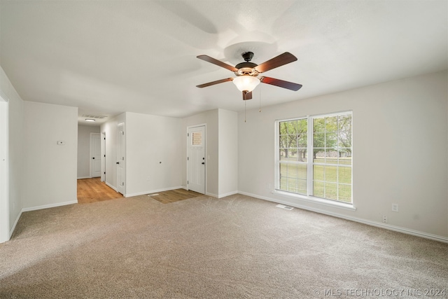 carpeted empty room featuring ceiling fan