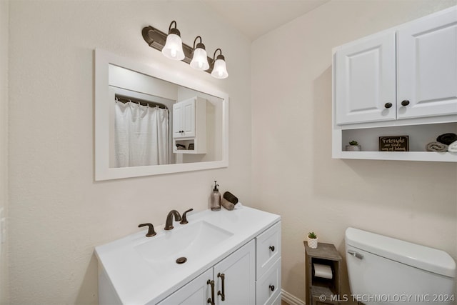 bathroom featuring toilet and vanity